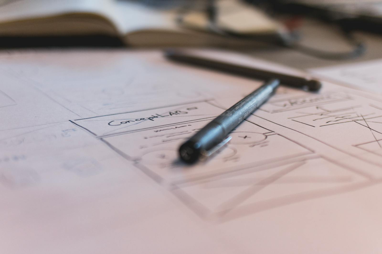 A sketch with notes and a pen on paper. Ideal for planning or design concepts.