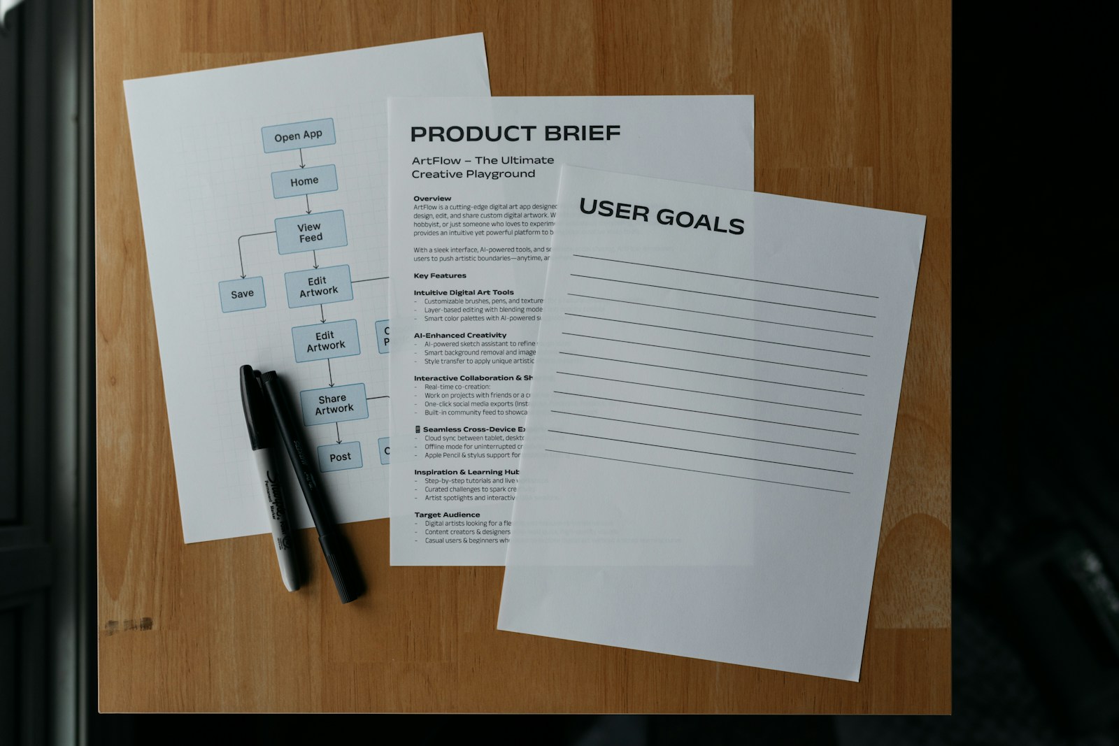 Documents and a pen lay on a wooden surface.