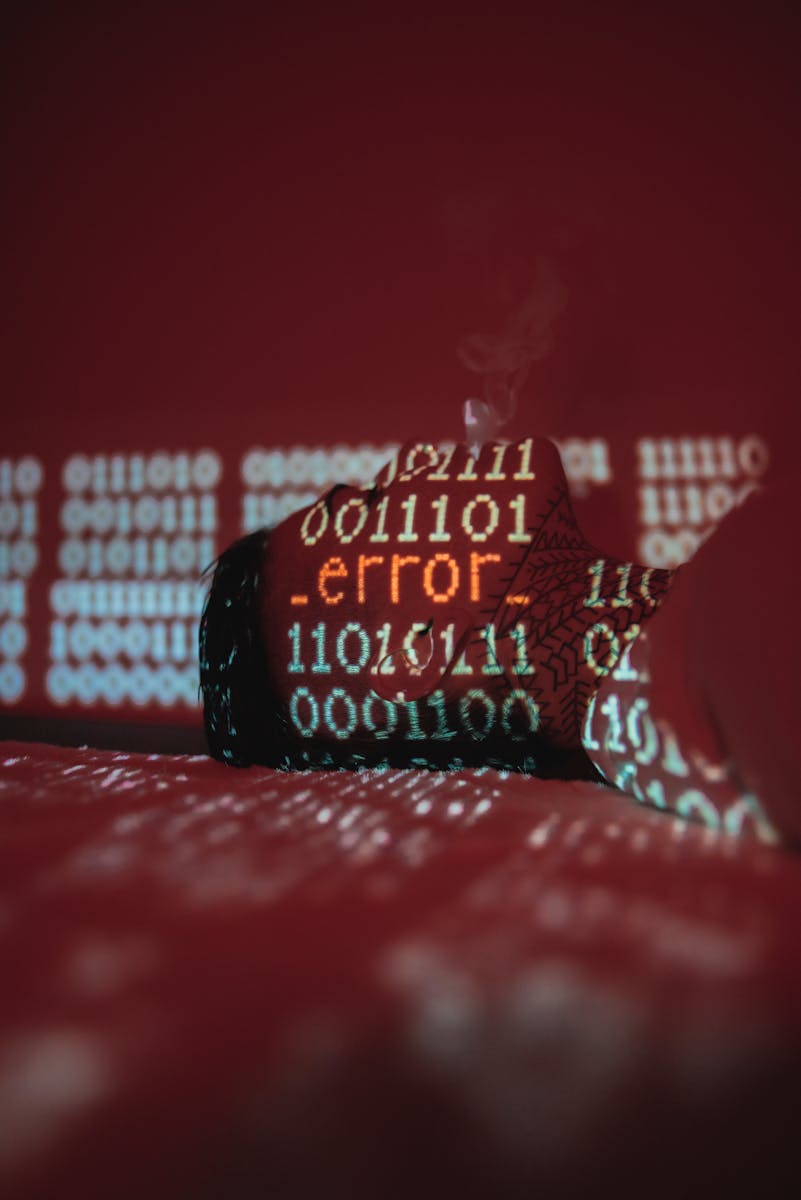A conceptual image showing error code projected on binary data with smoke.