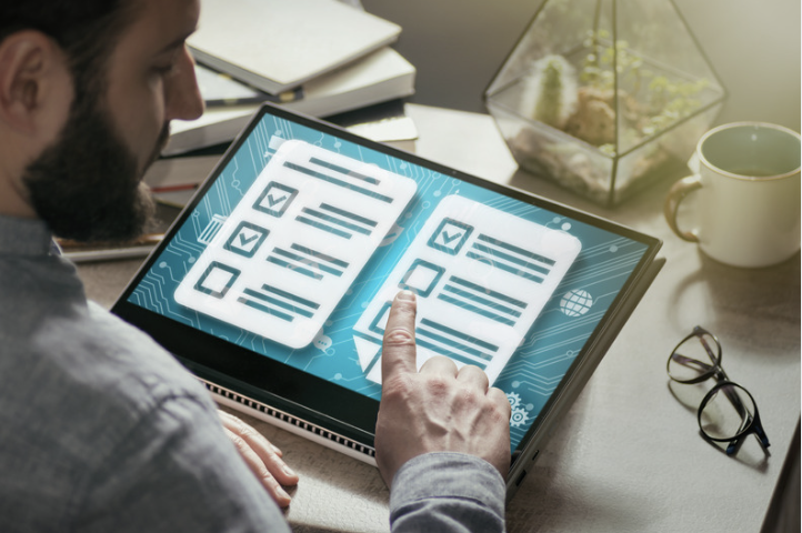 A person reviewing digital checklists on a touchscreen device, representing the process of website testing to verify functionality, usability, performance, and key technical elements before a website is launched or updated.